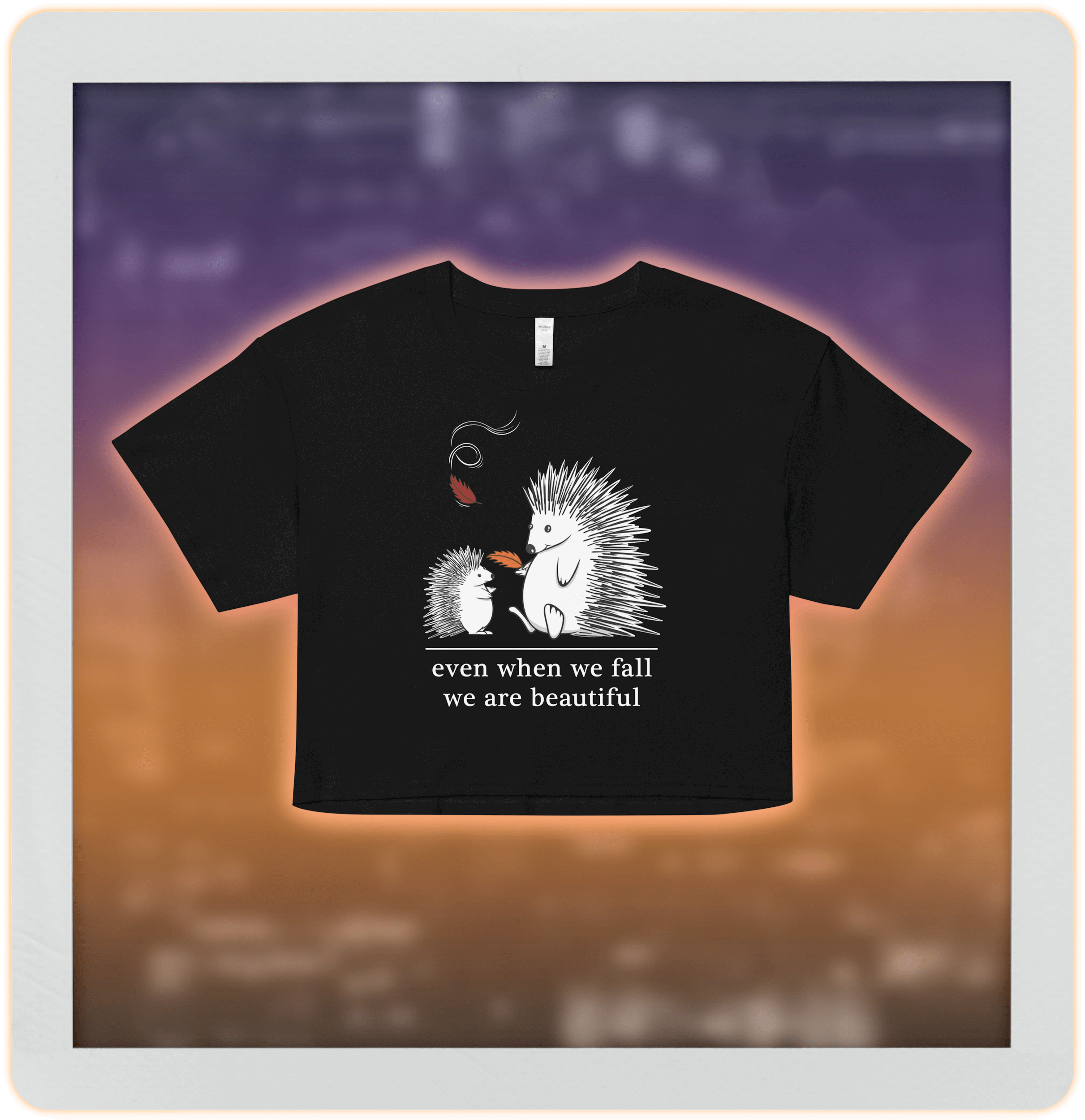 two cute hedgehogs in autumn leaves on black crop top